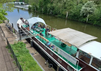 Thames Venturer boat moored at Teddington Lock for a School on the River programme on a sunny day.